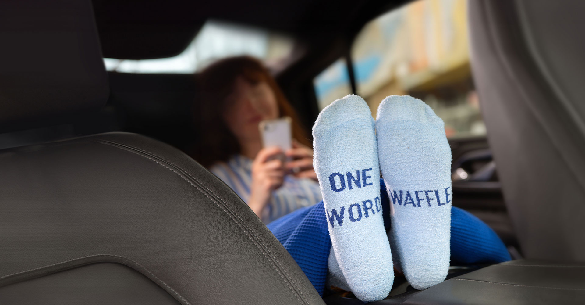 Woman sitting in car wearing Hampton Waffle Socks