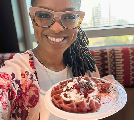 Woman taking selfie with waffles