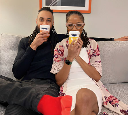Couple taking picture with Hampton mustache cups